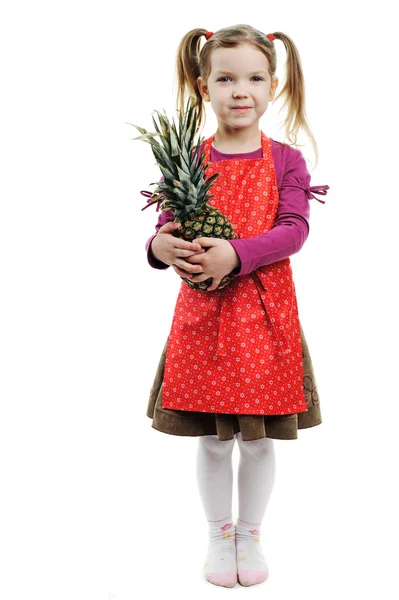 Een klein meisje met een lekker ananas — Stockfoto