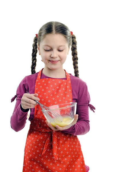 一个小女孩在一碗中搅拌的东西 — 图库照片