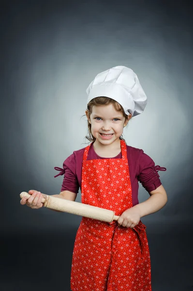 A nice girl in a white hat with a rolling-pin — Stock Photo, Image