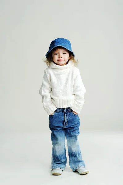 Stock image A little girl in a blue hat and white jumper