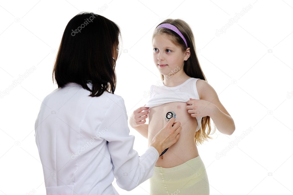A little girl being listened by a doctor