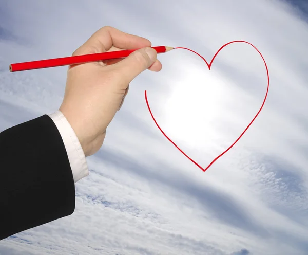 Hand with pencil draws the heart — Stock Photo, Image