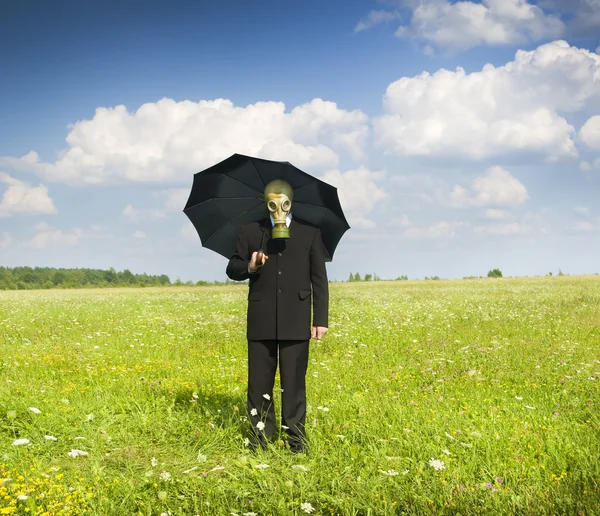 Man in gas-mask on meadow. — Stock Photo, Image