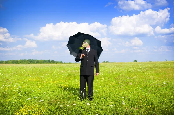 stock image Man in gas-mask on meadow.