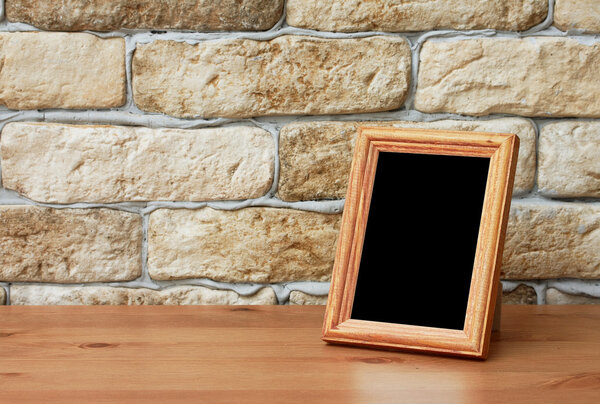 Old photo frame on the wooden table