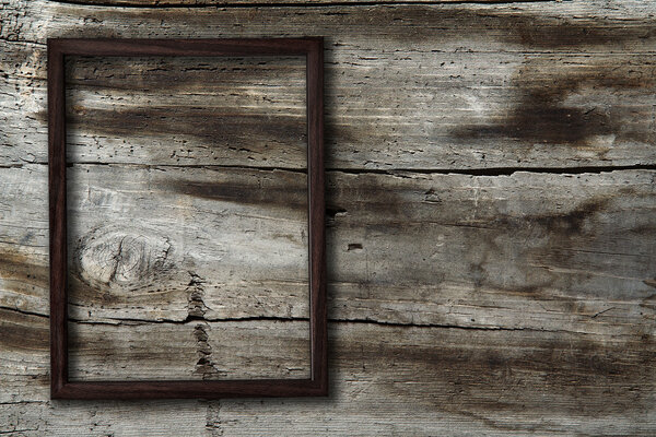 Blank photo-frame on old wooden background