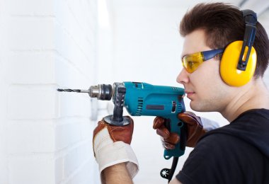 Man worker with drill clipart