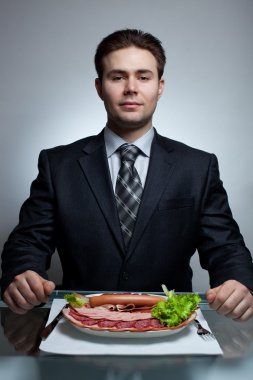 Young businessman eating clipart