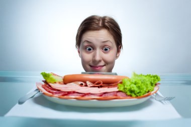 Young woman looking on plate