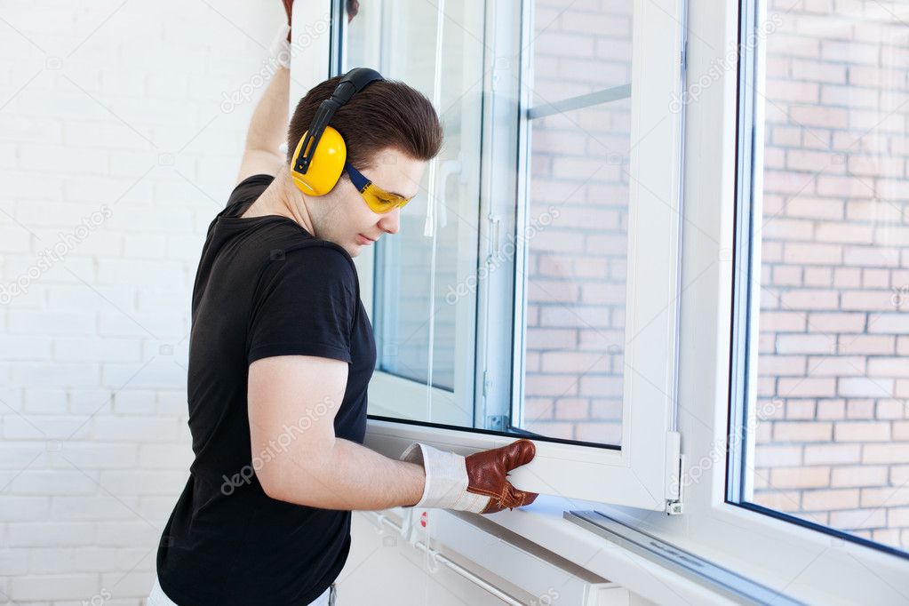 Man worker mounting window