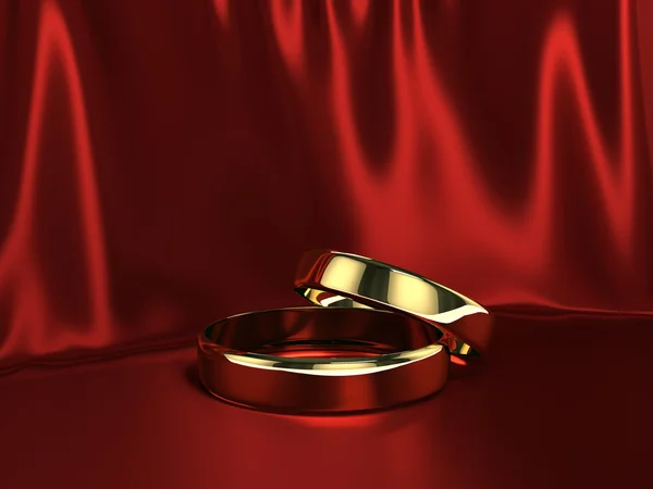 Two gold rings on red silk — Stock Photo, Image