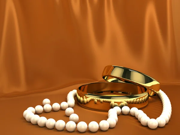 Dois anéis de ouro em seda vermelha — Fotografia de Stock