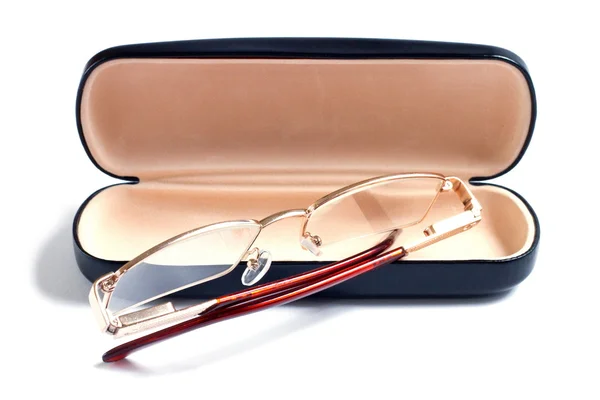 A glasses of gold color and case to them — Stock Photo, Image