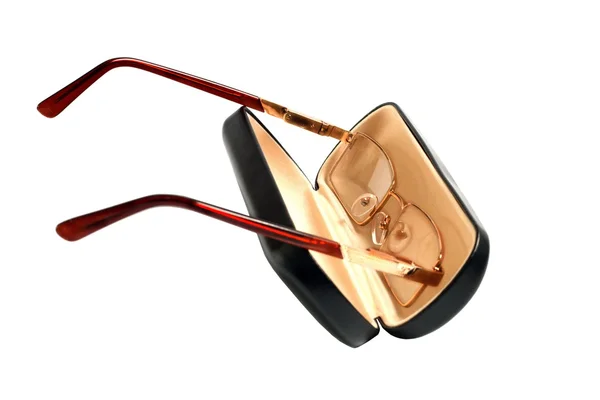 Glasses of gold color and case to them — Stock Photo, Image