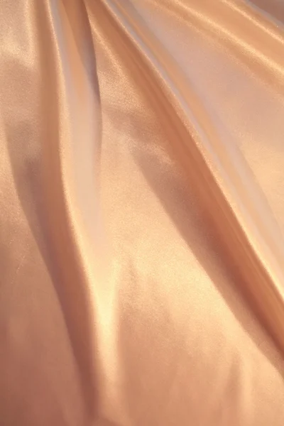 Гладкий елегантний рожевий золотий шовк як фон — стокове фото