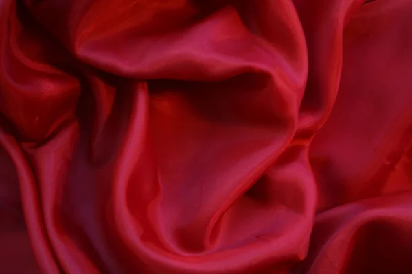 Гладкий красный шелк можно использовать в качестве фона — стоковое фото