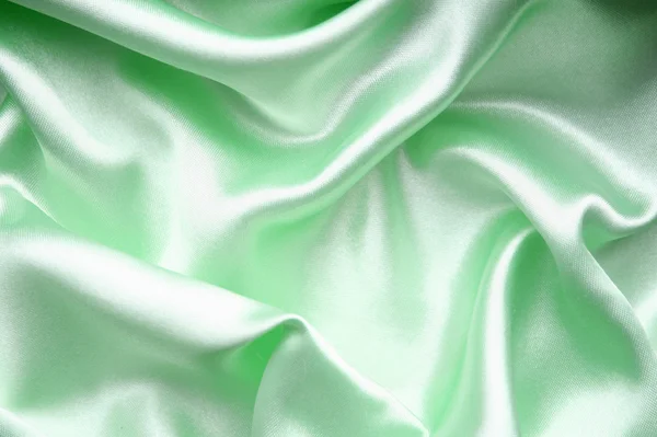 Hladké elegantní zelené hedvábí jako pozadí — Stock fotografie