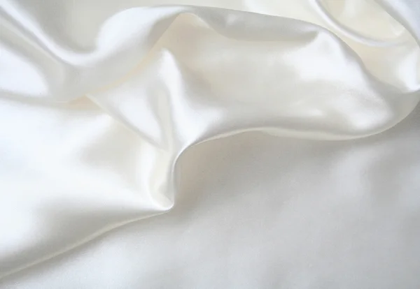 Glatte elegante weiße Seide kann als Hochzeitshintergrund verwendet werden — Stockfoto
