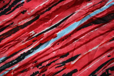 Blue, black and red strips on the fabric as background clipart