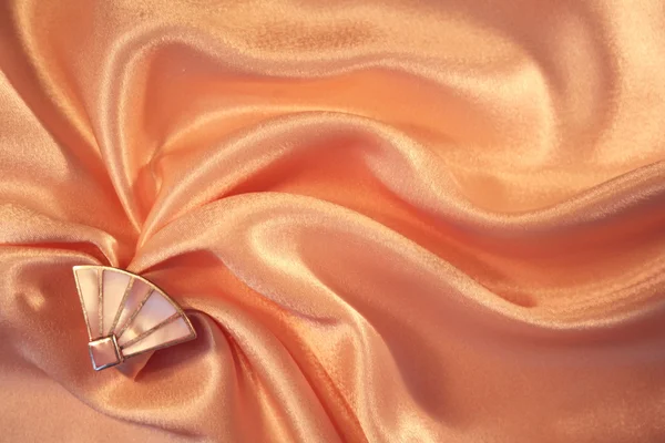 Silver fan from nacre on the elegant pink silk — Stock Photo, Image