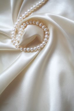 Smooth elegant white silk with pearls as wedding background clipart