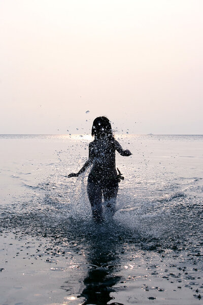 Girl splashing in Baltic sea water