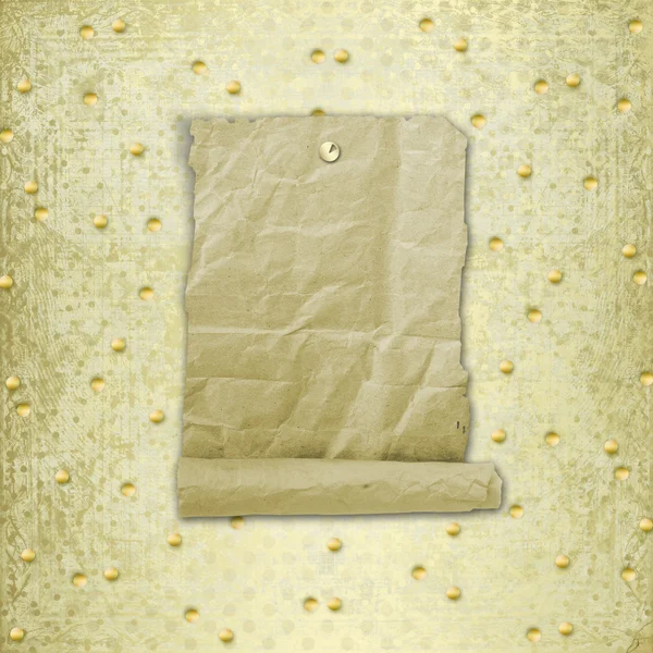 Old roll of paper hanging on a gold background — Stock Photo, Image