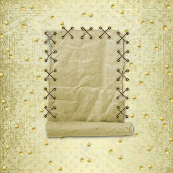 Old roll of paper hanging on a gold background — Stock Photo, Image