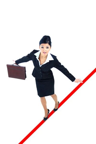 Young business woman walking on a tightrope nearly falling on white backgro — Stock Photo, Image
