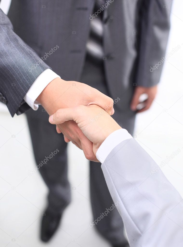 Handshake of business partners after signing promising contract