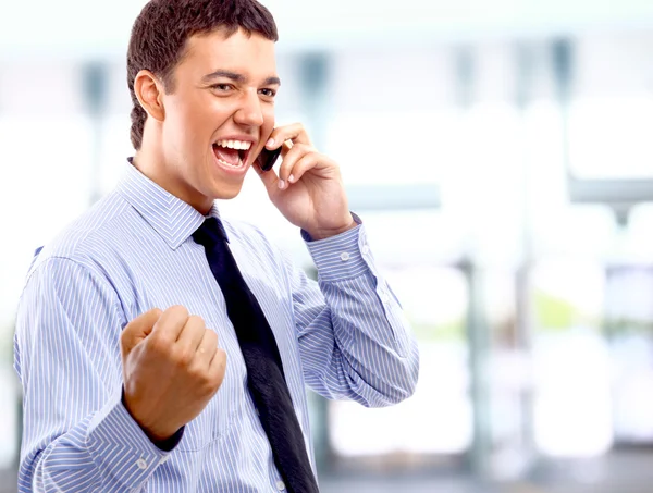 A young handsome business man on phone at office building — Stock Photo, Image