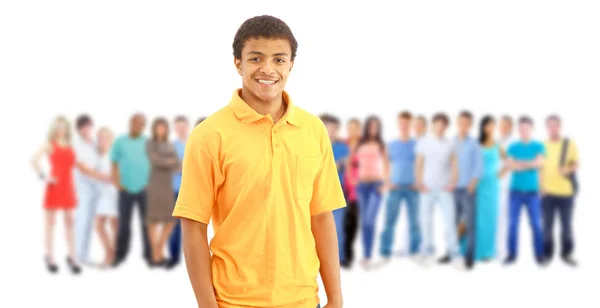 A young man with big group of the young smiling students. Over w — Stock Photo, Image