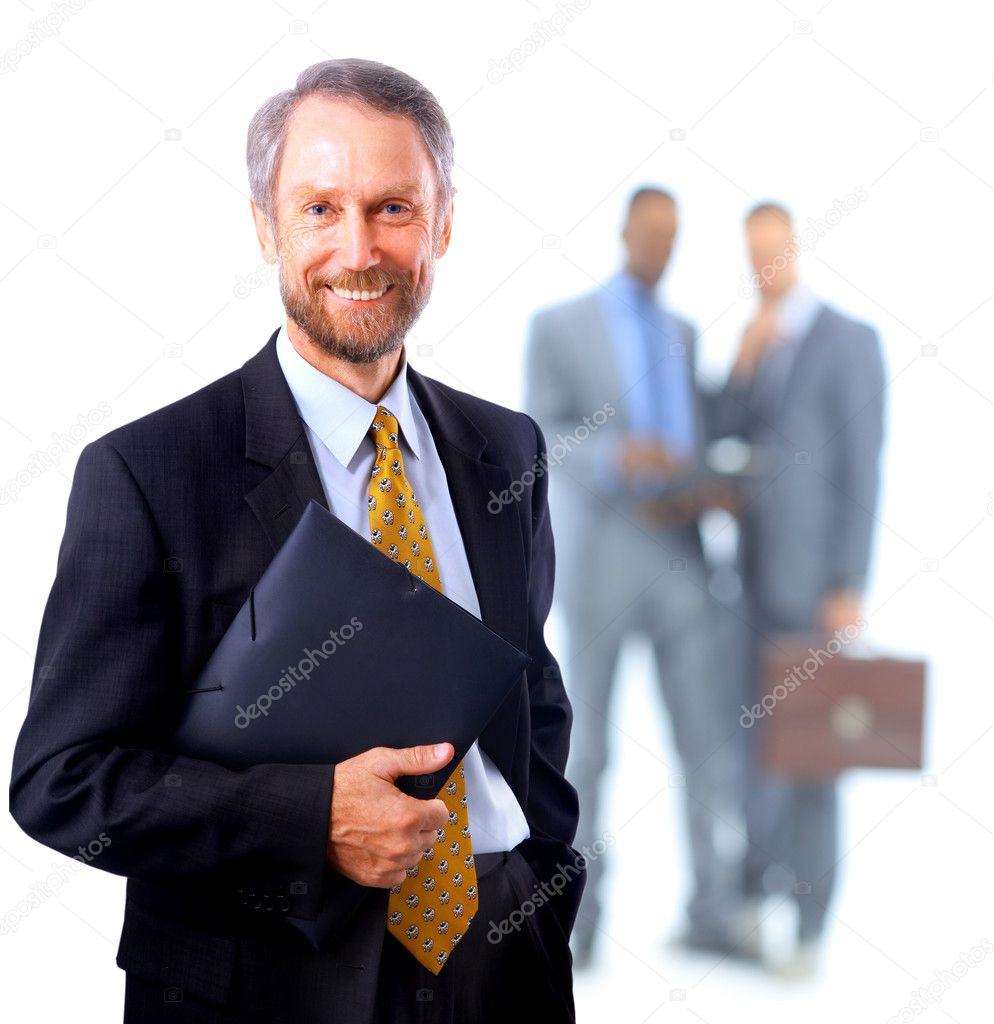 Successful business man standing with his staff in background