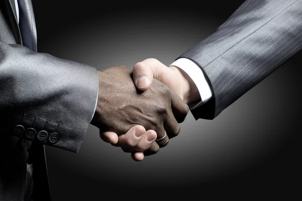 stock image Handshake - Hand holding on black background