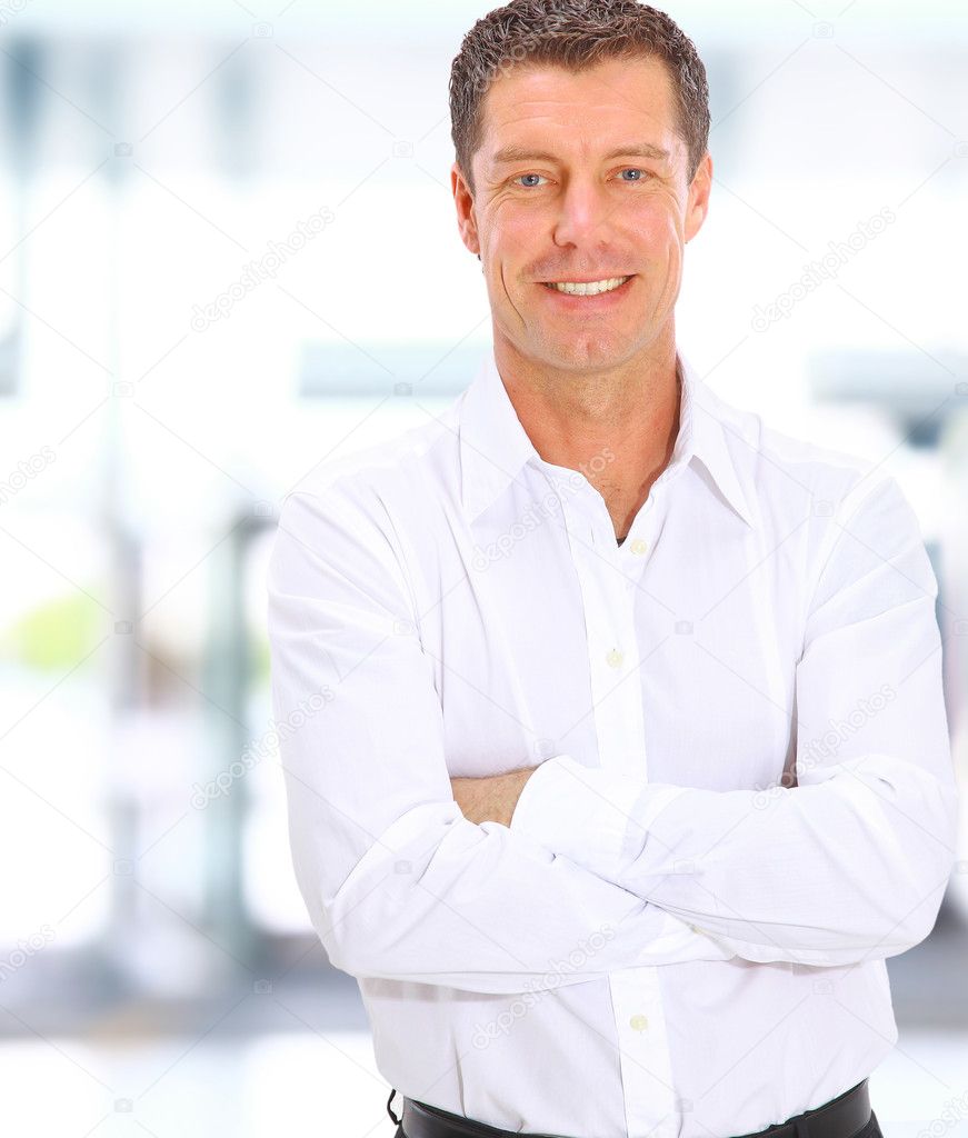 Business man looking at camera in the office with copy space