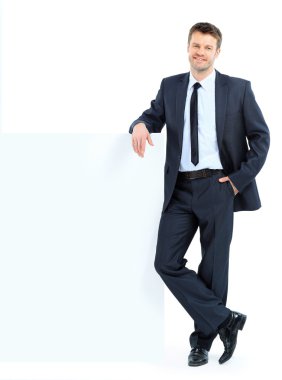 Portrait of happy smiling young business man showing blank signb clipart