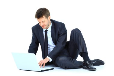 Happy young business man working on a laptop, isolated on white clipart