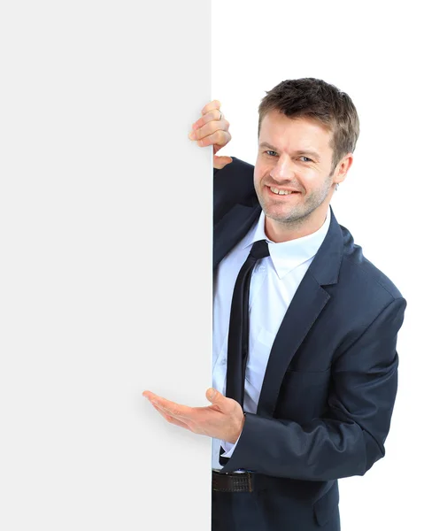 Felice uomo d'affari sorridente mostrando cartello bianco, solitario ove — Foto Stock