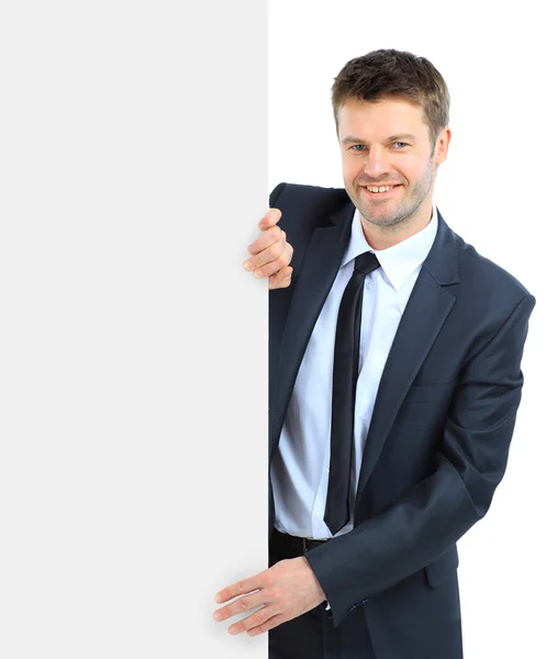 Ευτυχής χαμογελαστός άνθρωπος των επιχειρήσεων δείχνει κενό πινακίδα, απομονωμένη ΟΒΕ — Φωτογραφία Αρχείου