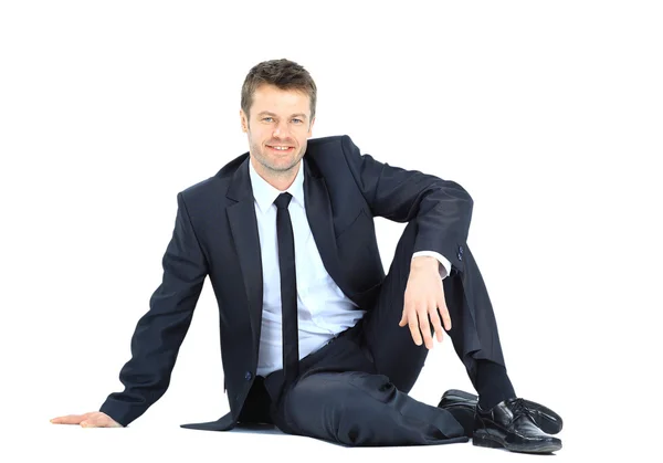Портрет бізнесмена, що сидить на підлозі ізольовано над білим — стокове фото