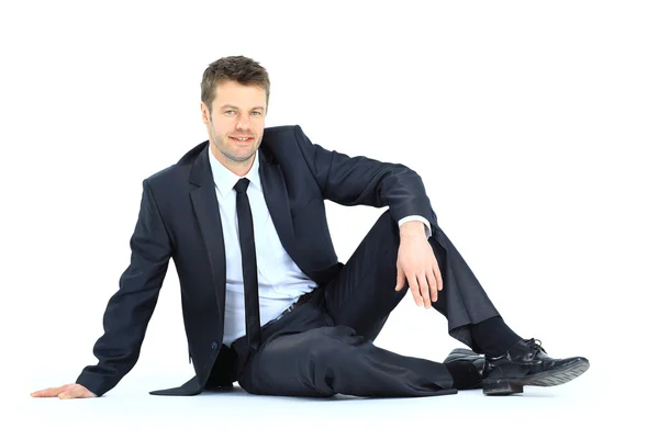 Portrait d'un homme d'affaires assis sur le sol isolé sur un coup de fouet — Photo