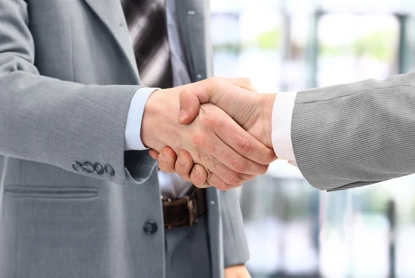 Business men in a handshake at the office — Stock Photo, Image