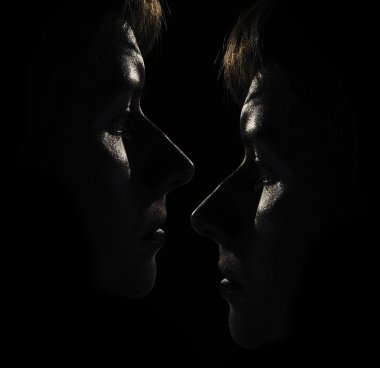 Two Women's Faces in the Dark clipart