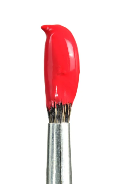 Schilderborstel met rode verf — Stockfoto