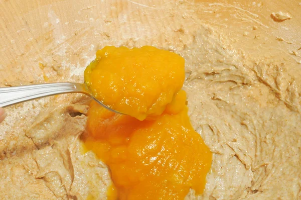 Pumpkin Puree Being Added into Bowl with Dough — Stock Photo, Image