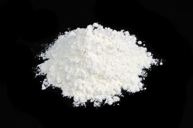 Pile of Flour on Black Background clipart