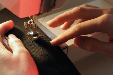 Tailor at Work on Sewing Machine clipart