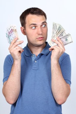 A man with a choice: rubles or dollars clipart