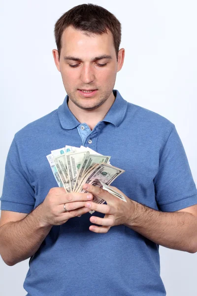 親指を現してお金を持つ男 — ストック写真