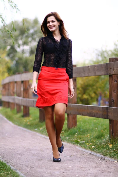 Walking woman red skirt — Stock Photo, Image